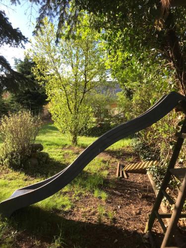 a large hose on a bench in a garden at Familienhaus in Arnsdorf