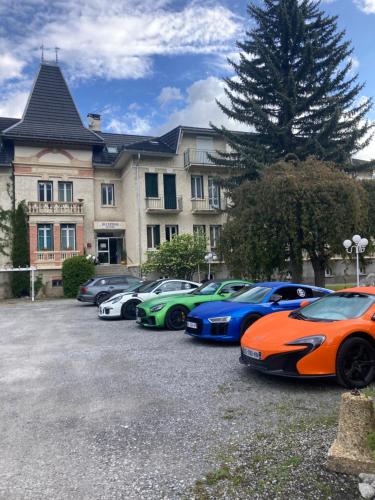 a row of expensive cars parked in front of a building at La Grande Eperviere in Barcelonnette