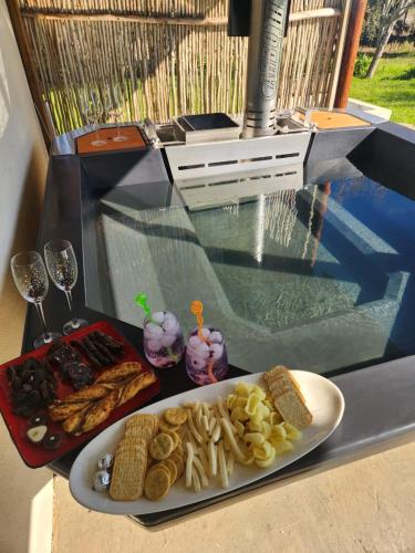 a glass table with a plate of food on it at Villa Wal Farmstay in Hartebeest Rivier