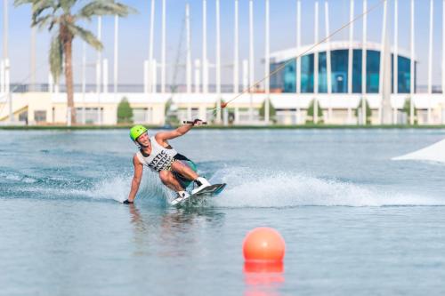a man water skiing on a body of water at Marriott Hotel Al Forsan, Abu Dhabi in Abu Dhabi