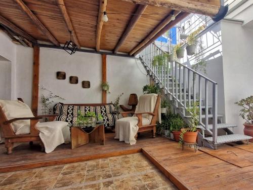an indoor patio with chairs and a staircase at Guesthouse Mendoza in Godoy Cruz