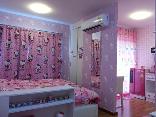 a bedroom with a pink bed with a pink curtain at The Trust Hua Hin kitty room in Hua Hin