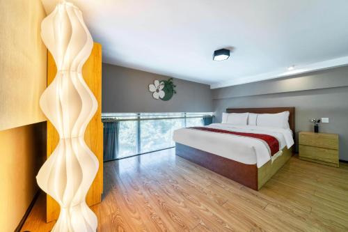 a bedroom with a large bed and a window at Plesant Daily Rental Apartment in Hangzhou