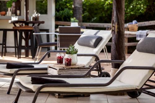 a group of chairs sitting on a patio at Villa Bermeja in Casares
