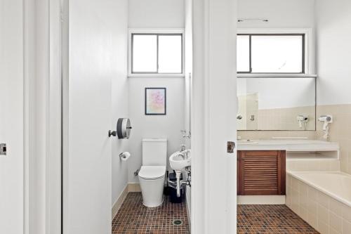 a bathroom with a toilet and a sink at Modern Private Double Room - Centrally Located - Shared Bathroom in Killara