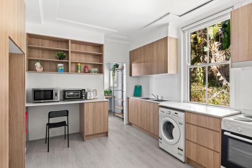 a kitchen with a washer and dryer at Modern Private Double Room - Centrally Located - Shared Bathroom in Killara