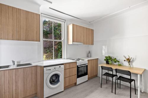 a kitchen with a washing machine and a washer at Modern Private Double Room - Centrally Located - Shared Bathroom in Killara