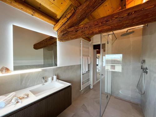 a bathroom with a sink and a shower at Jesolo Luxury Suites in Jesolo