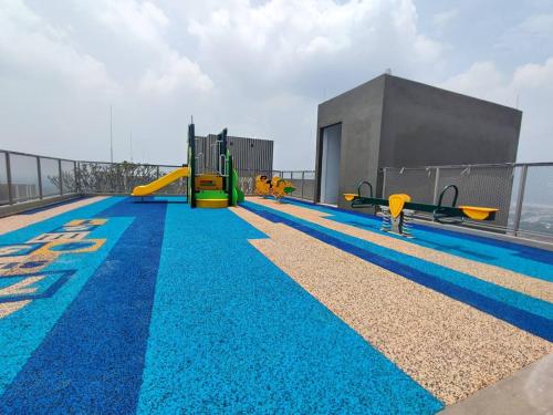 a pool with a playground on the top of a building at Youth City@Nilai in Nilai