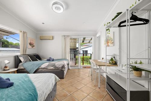 a bedroom with two beds and a bathroom with a sink at Quadruple Ensuite Room - Nearby Stations & Shops in Regents Park