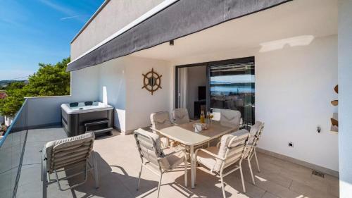 a patio with a table and chairs and a grill at Villa Bura in Barbat na Rabu