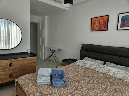 a bedroom with a bed with a dresser and a mirror at Serene Three-Bedroom Retreat in Unforgettable Setting in Kérynia