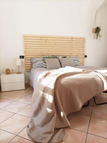 a bedroom with a bed with a blanket on it at Quick Home - Interno 45 in Biella