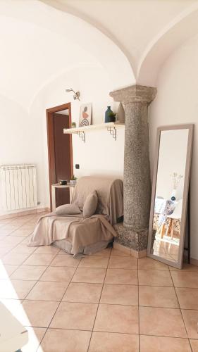 a bedroom with a bed in a room with a pillar at Quick Home - Interno 45 in Biella