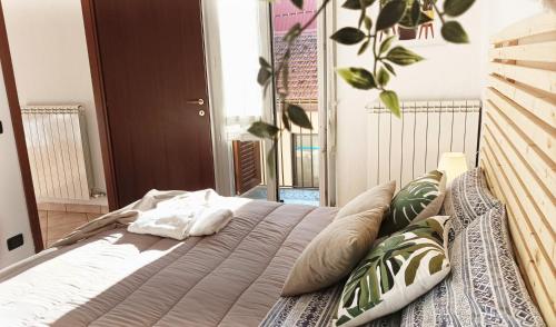 a bed in a bedroom with a plant on the wall at Quick Home - Interno 45 in Biella
