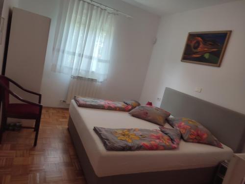 a small bedroom with a bed and a window at Apartmaji Jelena Piran in Piran