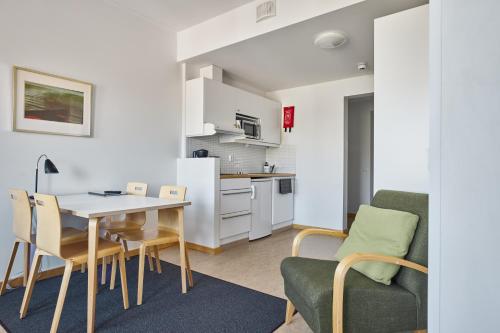 a kitchen and dining room with a table and chairs at Töölö Towers in Helsinki