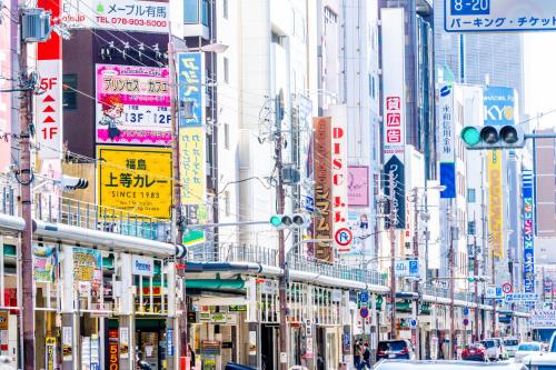 a busy city street filled with lots of signs at Osaka Tokyu REI Hotel in Osaka