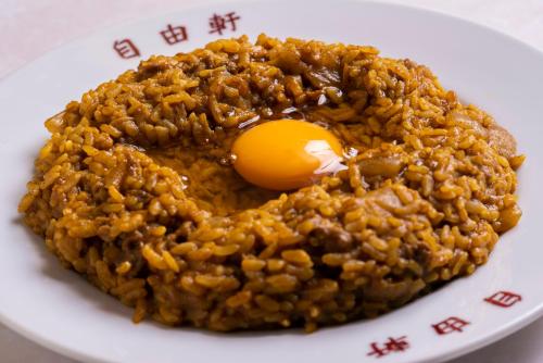 a plate of food with an egg on top at Osaka Tokyu REI Hotel in Osaka