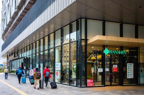 a group of people walking outside of a building at Osaka Tokyu REI Hotel in Osaka
