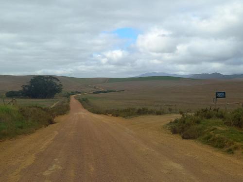 a dirt road in the middle of a field at Villa Wal Farmstay in Hartebeest Rivier