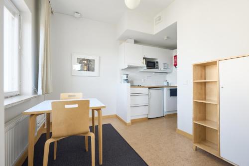 a kitchen with a table and chairs in a room at Töölö Towers in Helsinki