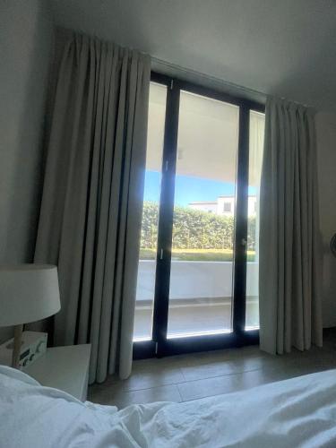 a bedroom with a large window with a view at Resort Le Maree Cannigione in Cannigione