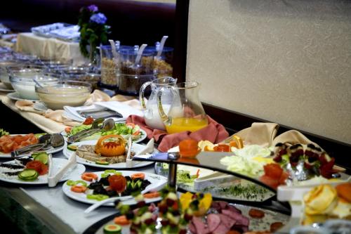 a table with many plates of food on it at Gülhanepark Hotel & Spa in Istanbul