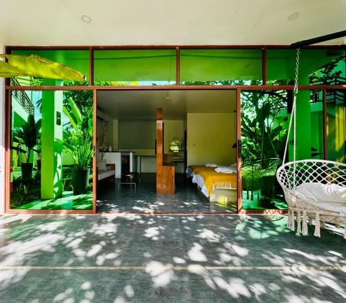 a bedroom with a bed in a room with green walls at 蓝色引力潜水度假村BLUE GRAVITY.WOW DIVING in Panglao