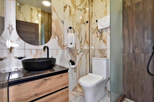 a bathroom with a toilet and a sink at Aygestan plaza in Yerevan