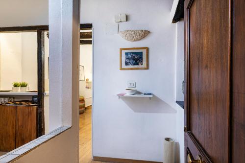 a room with a white wall with a shelf at Cozy Little House in Camogli by Wonderful Italy in Camogli