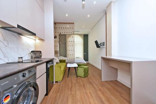 a kitchen and living room with a washer and dryer at Aygestan plaza in Yerevan