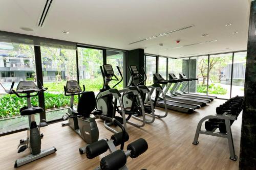 a gym with rows of treadmills and elliptical machines at The Deck Condominium Patong Beach in Patong Beach