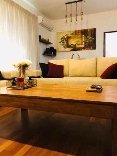 a living room with a couch and a coffee table at Luxurious Fully Furnished Apartment for Rent at 2000 Plaza, Colombo in Sri Jayewardenepura Kotte