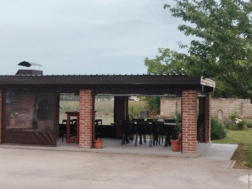 a pavilion with a table and chairs in a yard at Sleep and Fly room's by Dado & Lela in Velika Gorica