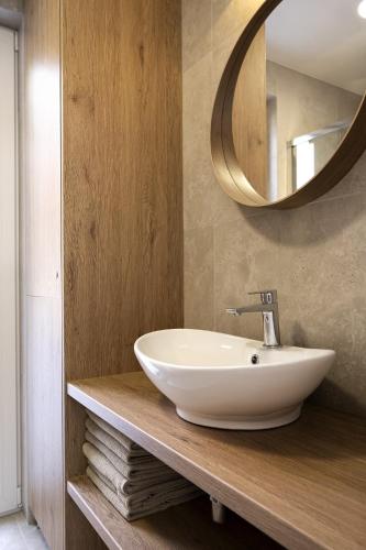 a bathroom with a white sink and a mirror at Warmiński Sad in Olsztyn