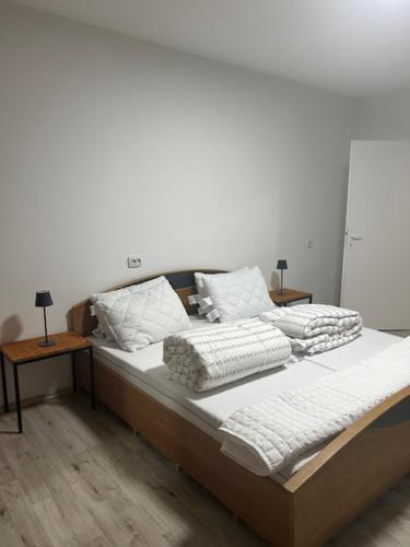 a bed with two pillows on it in a room at Sleep and Fly room's by Dado & Lela in Velika Gorica
