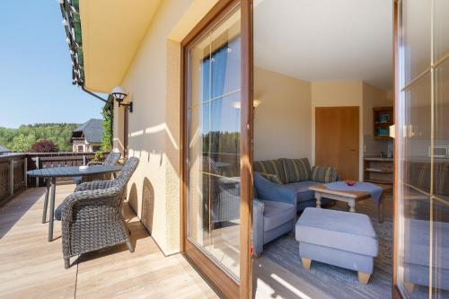 a balcony with a couch and a table at Pension Bergblick in Marienberg