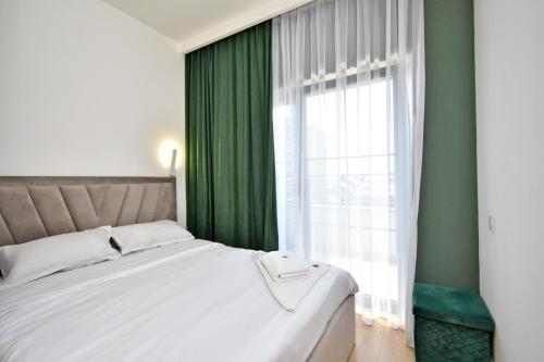 a bedroom with a large bed and a window at Aygestan plaza in Yerevan