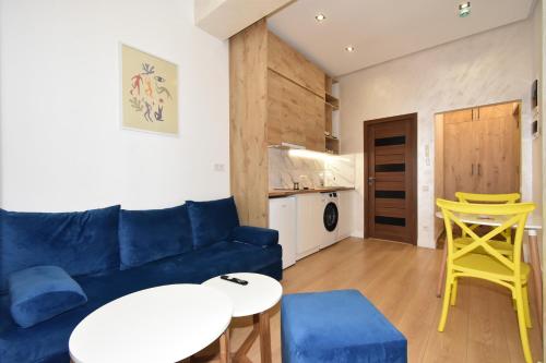 a living room with a blue couch and a table at Aygestan plaza in Yerevan