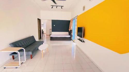 a living room with a couch and a bed in a room at Area Indahpura or Taman Bersatu Kulai 3-4BR near AEON Airport JPO in Kulai