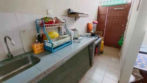 a kitchen with a sink and a counter top at Area Indahpura or Taman Bersatu Kulai 3-4BR near AEON Airport JPO in Kulai