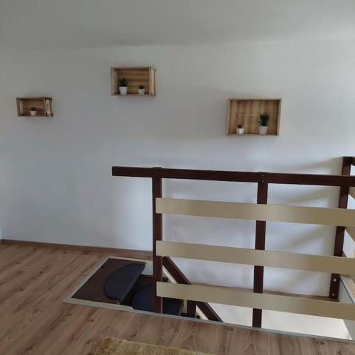 a room with a white wall and a wooden floor at Ferienparadies Haus Monica in Palting