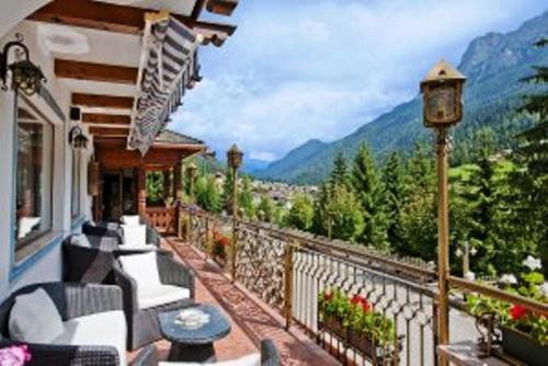 a balcony of a house with a view of the mountains at Hotel Des Alpes in Soraga