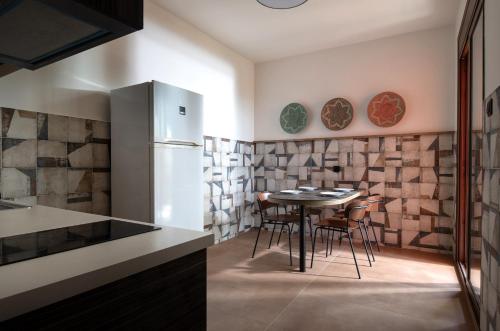 Sunday Resort في غيراكيني: مطبخ مع طاولة وكراسي وثلاجة