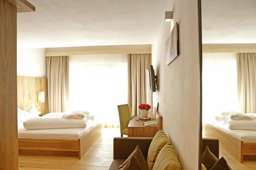 Ένα ή περισσότερα κρεβάτια σε δωμάτιο στο Hotel Stoeres - Active wellbeing