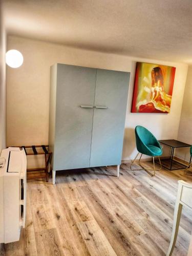 a room with a cabinet and a green chair at Bed&Breakfast Villa Devoto" La Torretta" in Rapallo