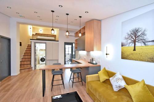 a kitchen and living room with a couch and a table at Aygestan plaza in Yerevan