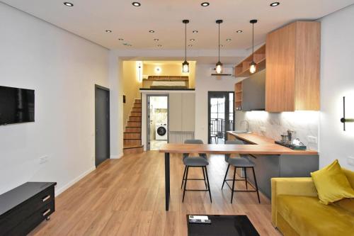 a kitchen and living room with a table and a couch at Aygestan plaza in Yerevan