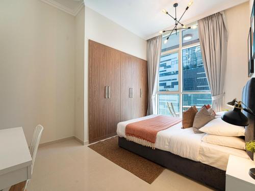 a bedroom with a bed and a large window at Luxe Apartments near Dubai Mall Burj Khalifa Pool Gym Parking in Dubai